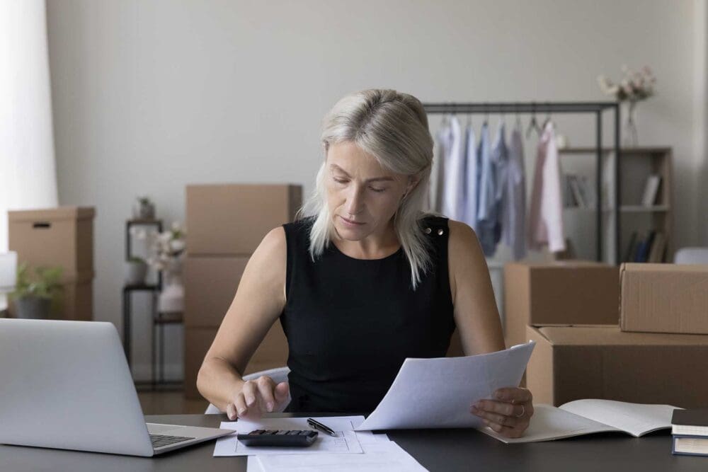 woman calculating storage costs on calculator